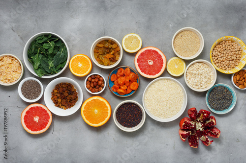 Clean eating concept. Vegetarian healthy food - different vegetables and fruits, superfood, seeds, cereal, leaf vegetable on light background, top view