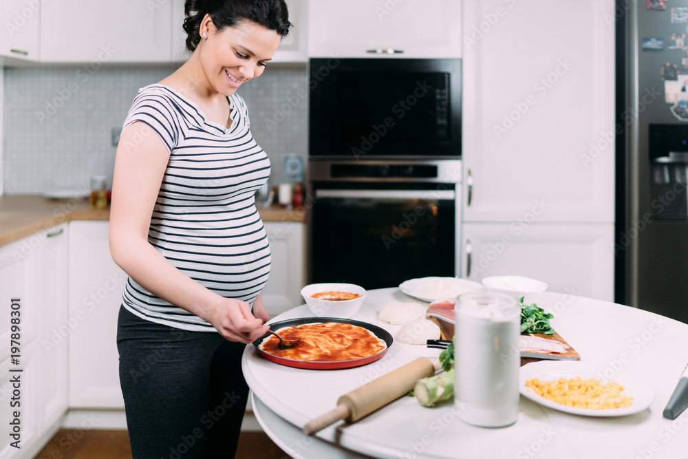 Young mother cooking dinner at home
