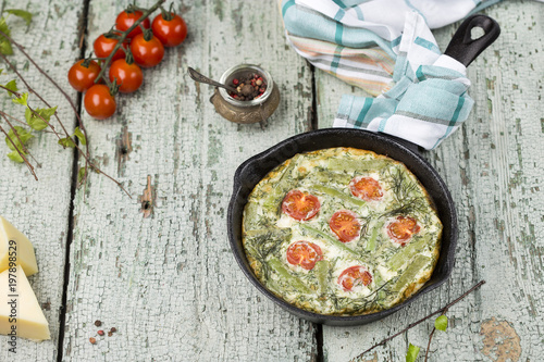 classic omelet with cherry tomatoes, cheese and herbs