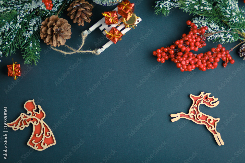 Christmas and New Year background with gifts, deer, stars and fir-trees, flat lay on a dark blue background, holiday greetings Christmas and New Year background with gifts, deer, stars and fir-trees, flat lay on a dark blue background, holiday greetings
