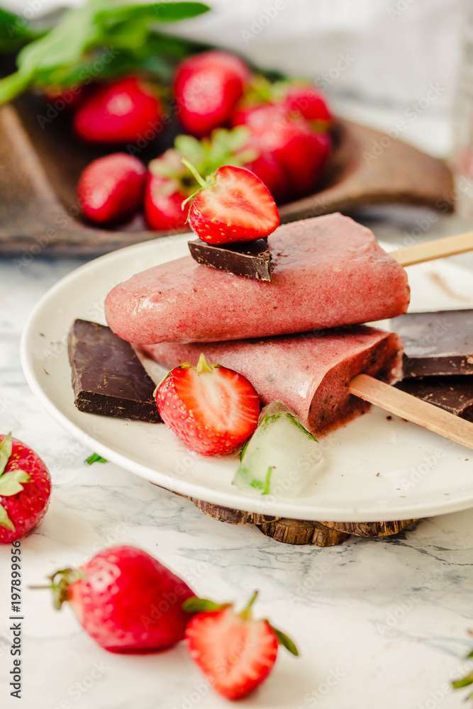 Strawberry ice cream with chocolate popsicles. Raw dessert. Mint. Detox diet and summer food concept.Selective focus. Strawberry ice cream with chocolate popsicles. Raw dessert. Mint. Detox diet and summer food concept.Selective focus.