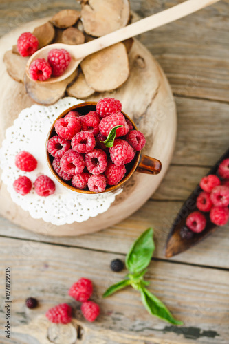 Fresh raspberry with basil in a cup of coffee and a wooden stand.Detox diet food and raw vegan concept.