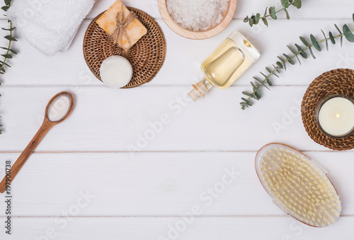 Cosmetics and accessories for body care on he white wooden table.
