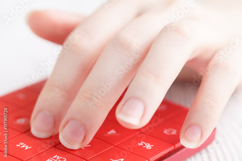 Female hand with calculator