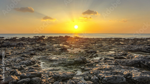 Rocky beach uncovered in low tide during evening sunset light with some clouds over horizon. Koh Lanta, Thailand © Lubo Ivanko