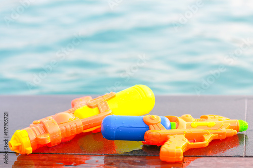 Water guns nearby the swimming pool.