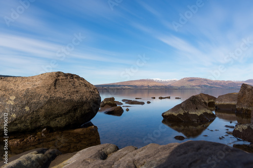 a low perspective view over the freshwater of Loch Lomond Scotland captured with a long exposure