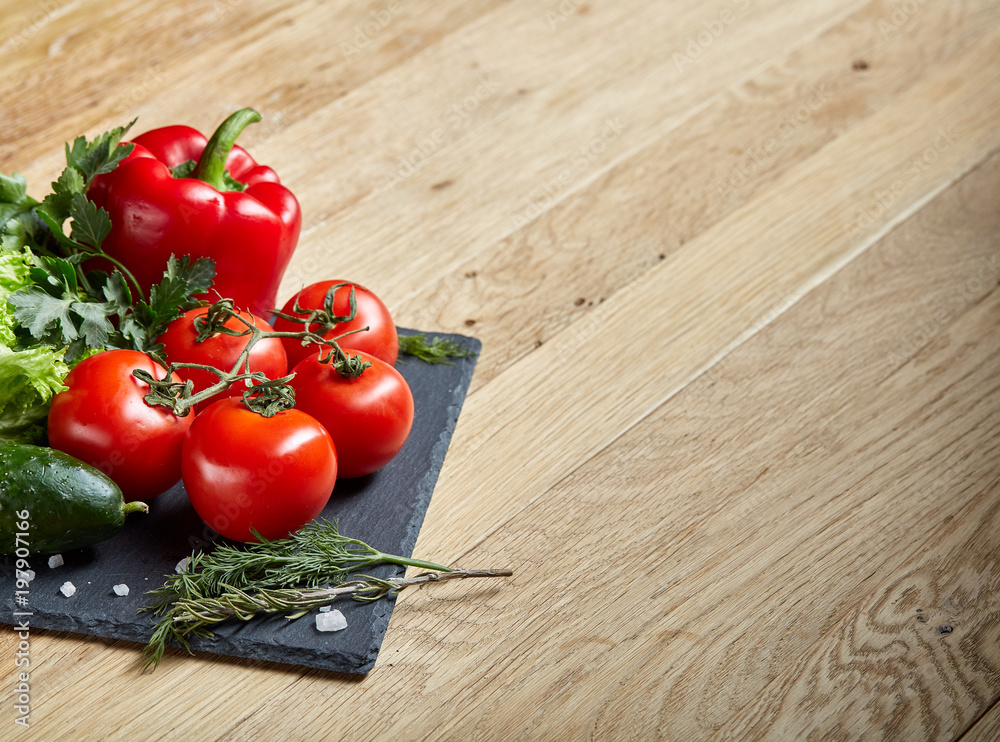 Close-up still life of assorted fresh vegetables and herbs on wooden rustic background, top view, selective focus. Close-up still life of assorted fresh vegetables and herbs on wooden rustic background, top view, selective focus.