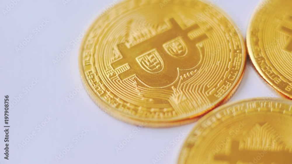 Macro shot of golden bitcoins rotating on background Macro shot of golden bitcoins rotating on background