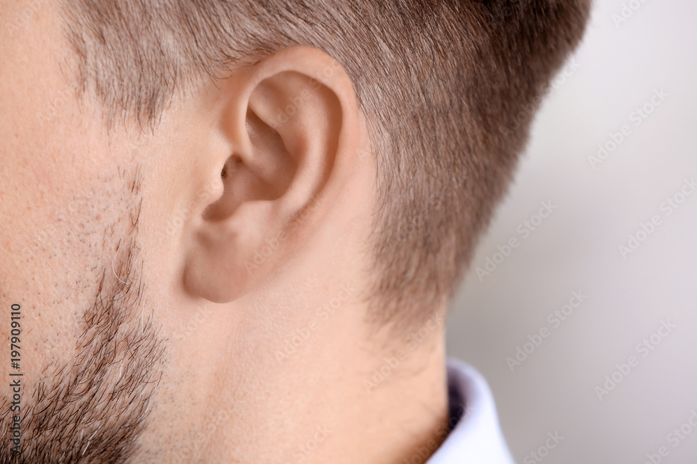 Mature man, closeup. Hearing problem