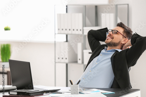 Handsome businessman relaxing in office photo