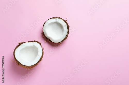 Coconut halves on color background