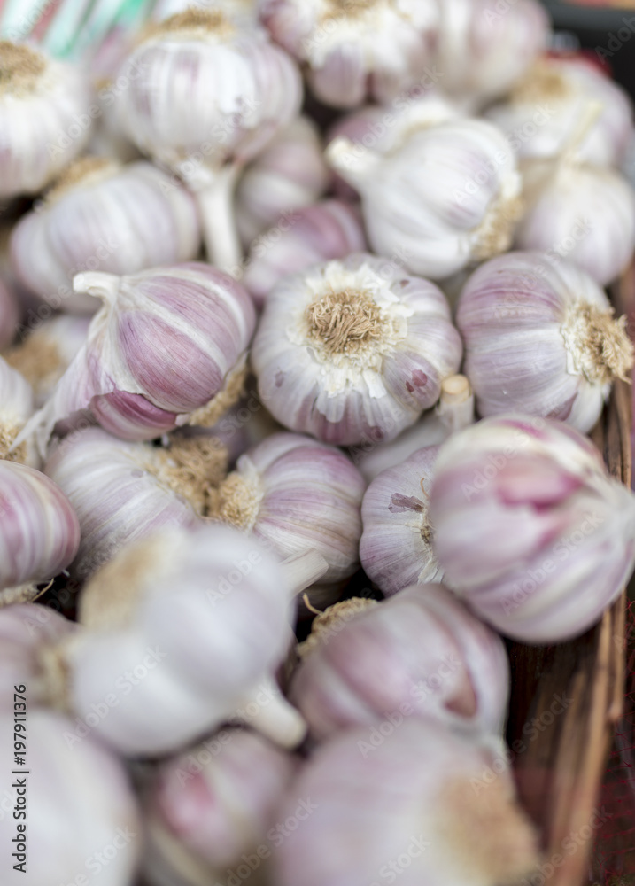 Fresh and organic garlic cloves close up on a farmers market stall in the UK Fresh and organic garlic cloves close up on a farmers market stall in the UK