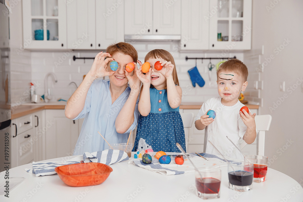 Preparation for Easter. Cheerful family paints eggs and shows them. Friendly family. Preparation for Easter. Cheerful family paints eggs and shows them. Friendly family.