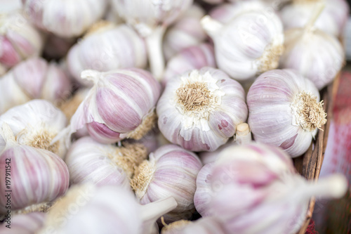 Fresh and organic garlic cloves close up on a farmers market stall in the UK
