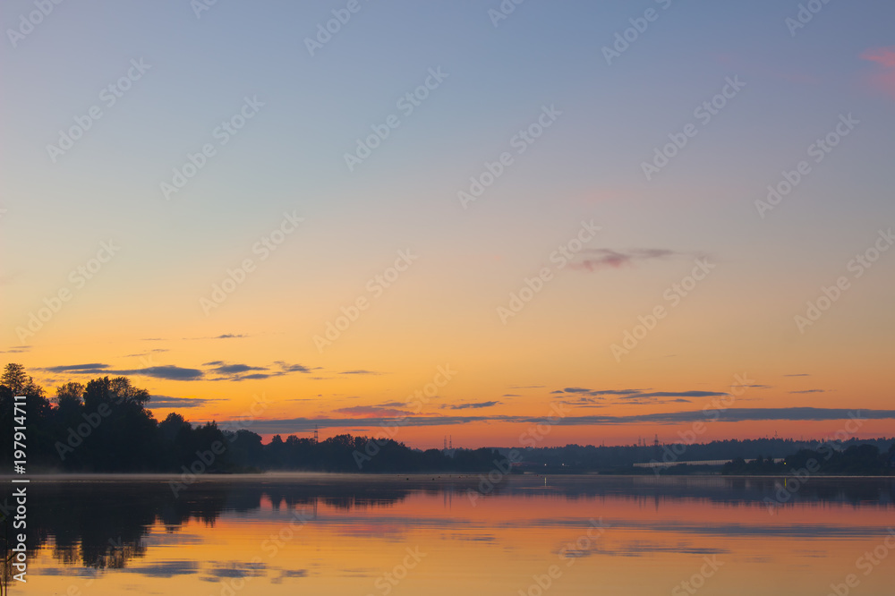beautiful landscape of the lake at sunset. blue sky and orange glow.