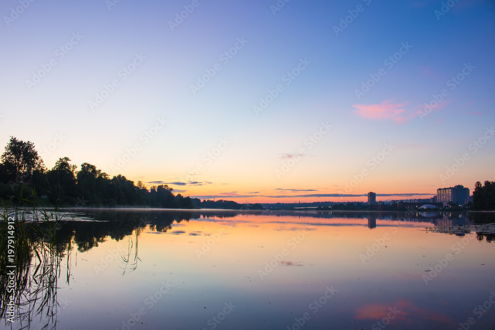 beautiful landscape of the lake at sunset. blue sky and orange glow.