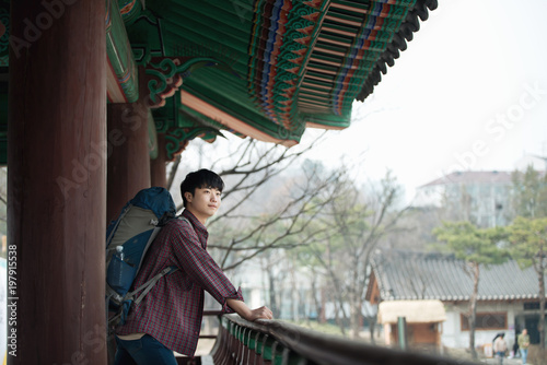 Canvas Print A young man doing a backpacking trip in a Korean traditional house