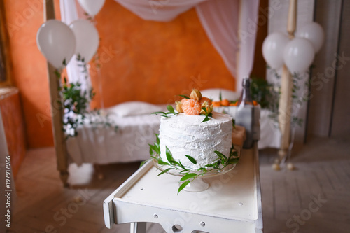 Gender reveal cake on baby shower party in room design moroccan style with orange walls and a canopy bed