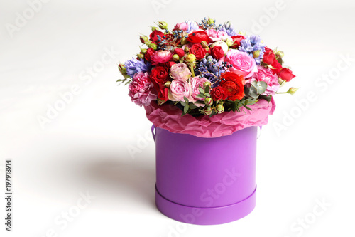 Fototapeta Naklejka Na Ścianę i Meble -  Beautiful bouquet of different flowers in a hat box.