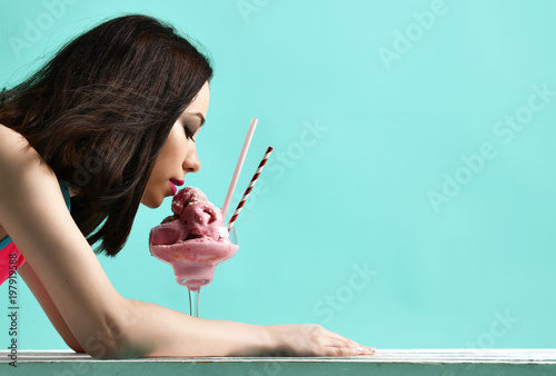 Valokuvatapetti Young woman in pink hat eat strawberry ice-cream dessert on modern light blue