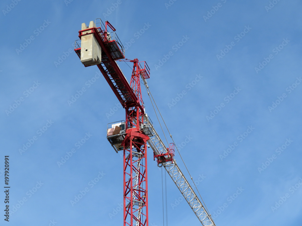 Construction crane against the blue sky	