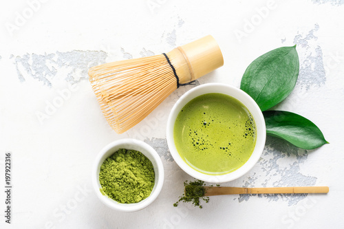 Green matcha tea drink and tea accessories on white background photo