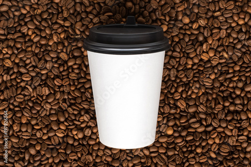 paper coffee cup on coffee beans background. Mock Up