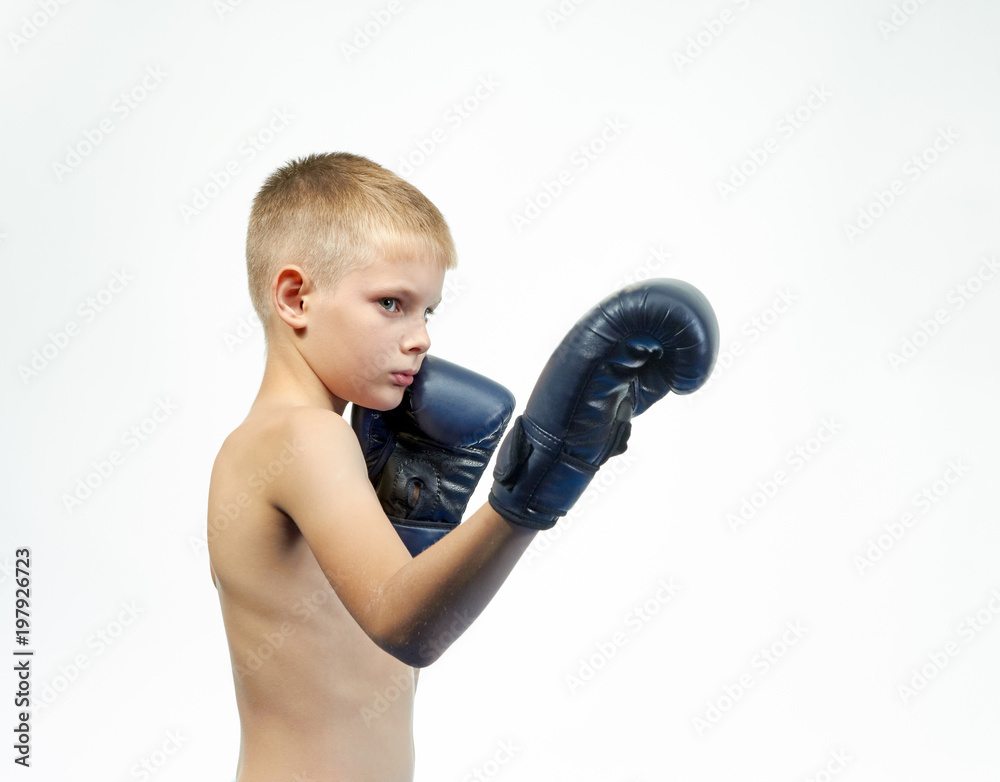 Boy in boxing gloves beats punch leg Boy in boxing gloves beats punch leg