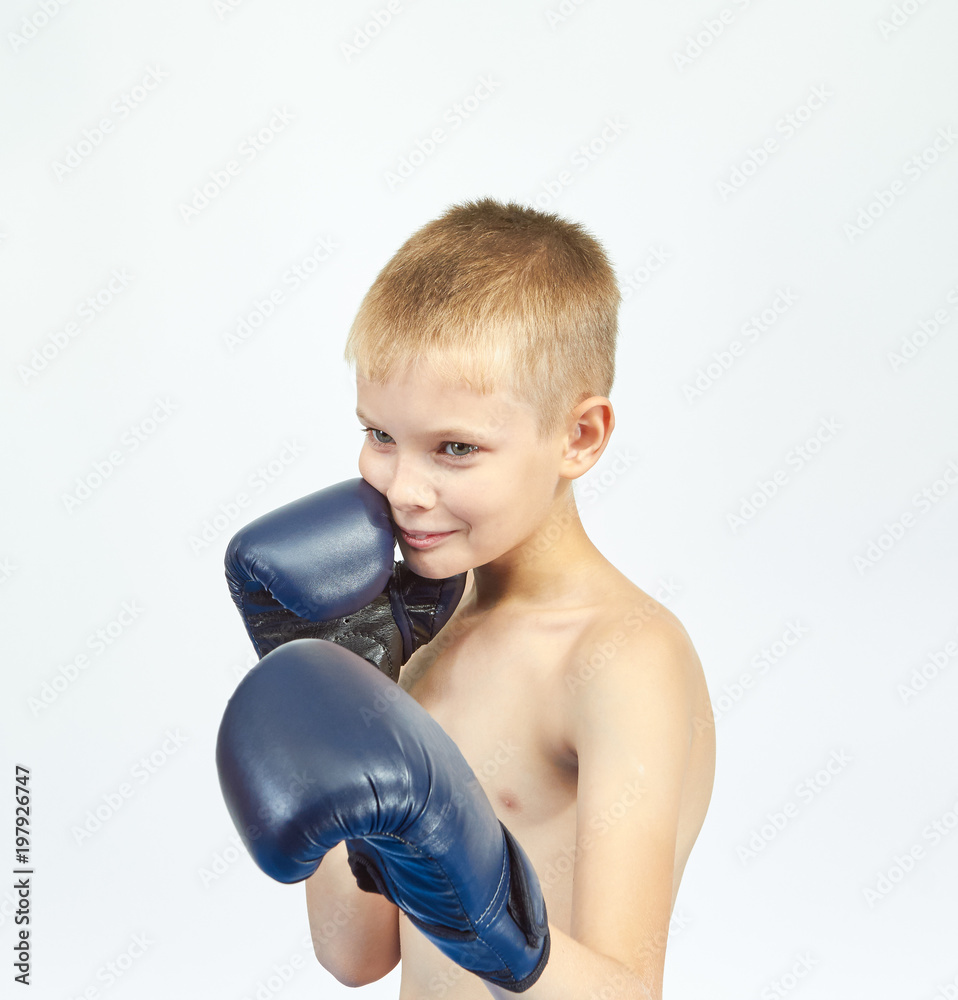 On a light background athlete with boxing gloves on his hands On a light background athlete with boxing gloves on his hands