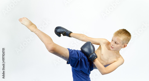 Boy in boxing gloves beats punch leg