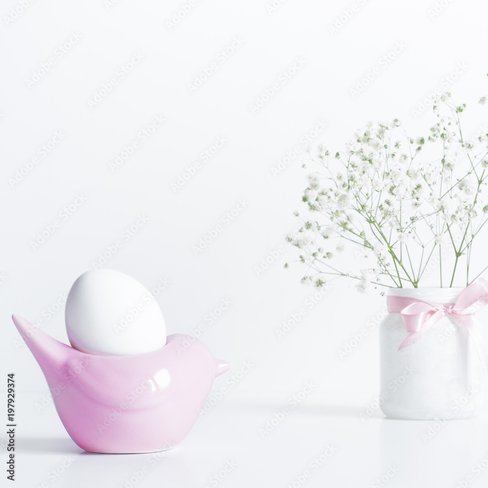 White Egg in Pink Bird Shape Stand.Easter Composition