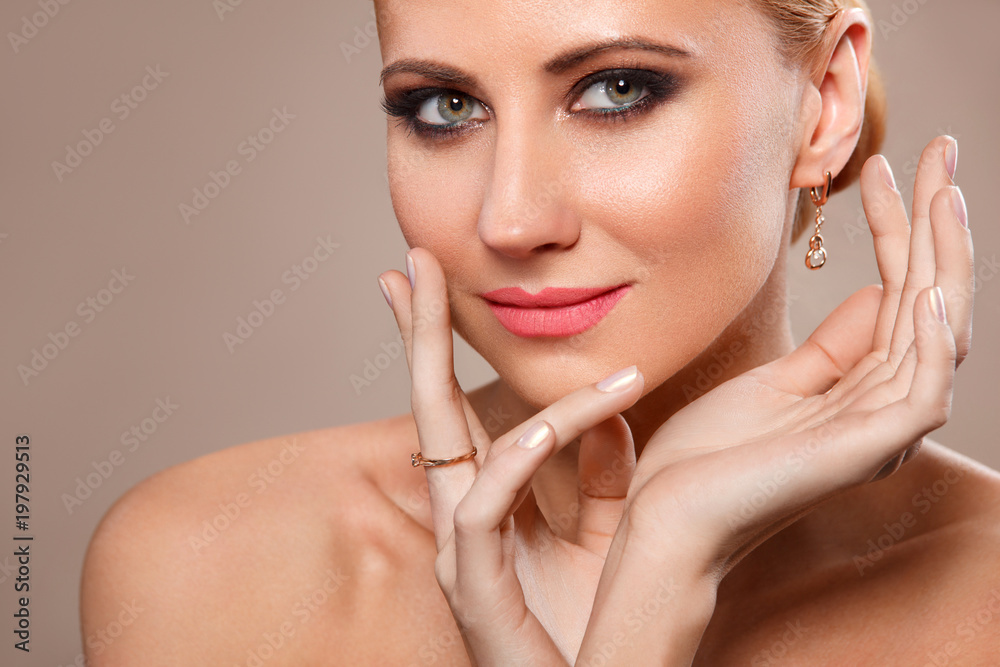 Fototapeta premium Beautiful Young Woman with Clean Fresh Skin touch own face . Facial treatment . Cosmetology, Beauty and spa .