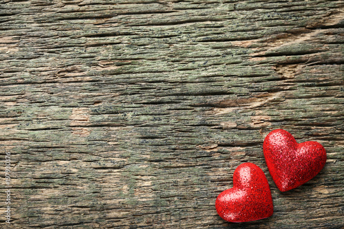 Red hearts on grey wooden table