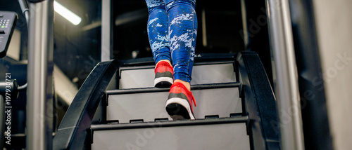 Panorama of girl on stairway machine