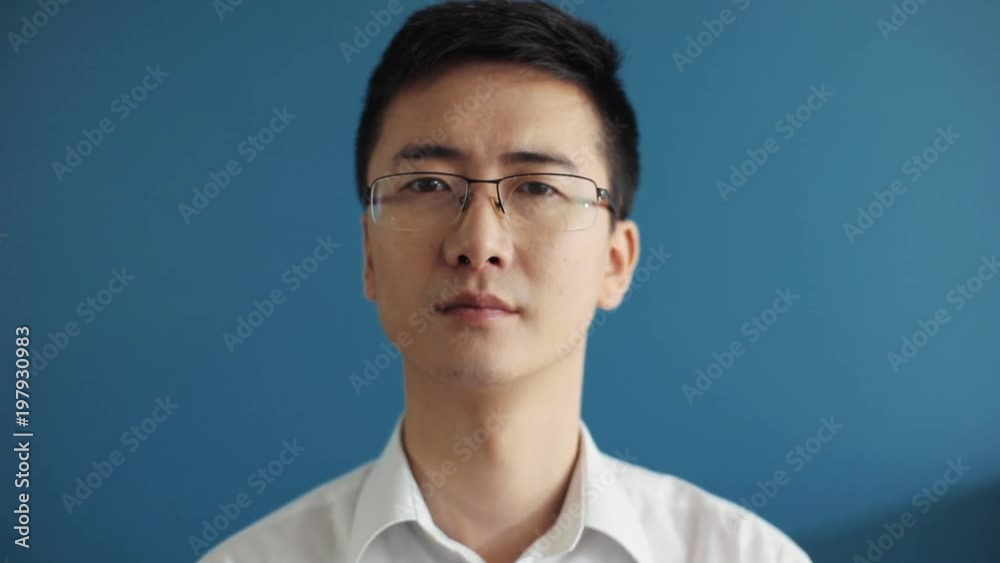 Serious face asian businessman with glasses look at camera portrait in office japanese movement suits wearing working business adult arms cute slow motion self-employed street success executive Serious face asian businessman with glasses look at camera portrait in office japanese movement suits wearing working business adult arms cute slow motion self-employed street success executive