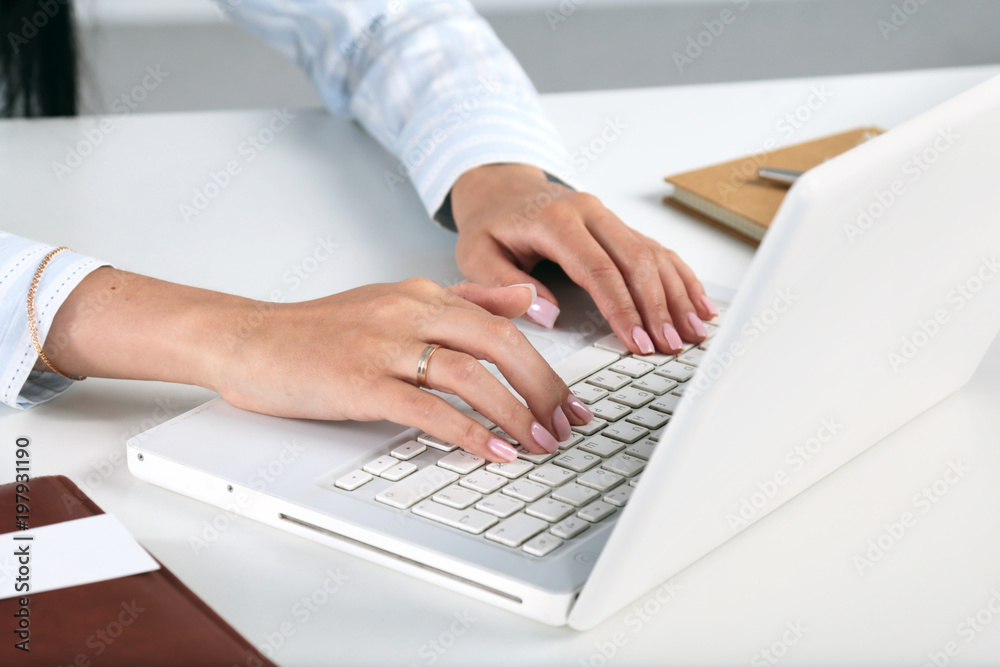 Female office worker typing on the keyboard Female office worker typing on the keyboard