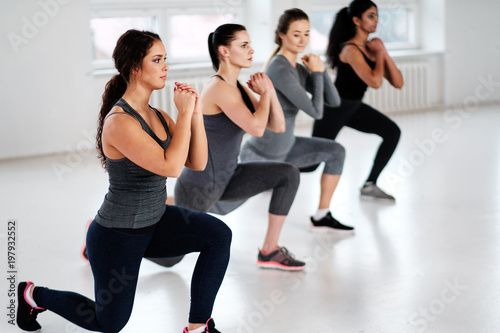 Group of young people doing fitness exercices.