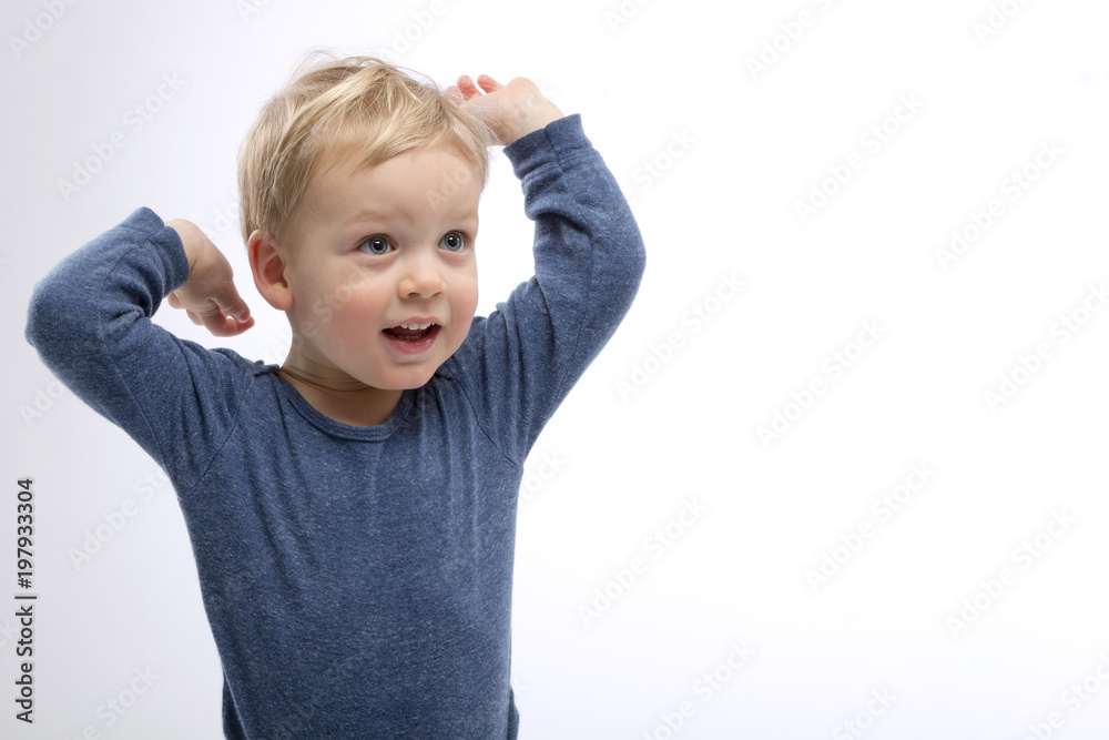 Excited blonde toddler with hands up. Isolated. Studio shot. Copy space Excited blonde toddler with hands up. Isolated. Studio shot. Copy space