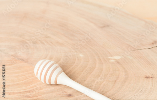 Spoon for honey on a wooden background. Element of workpiece for a collage