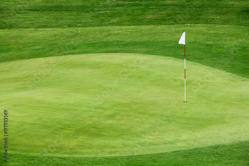 Golf flag on the green grass