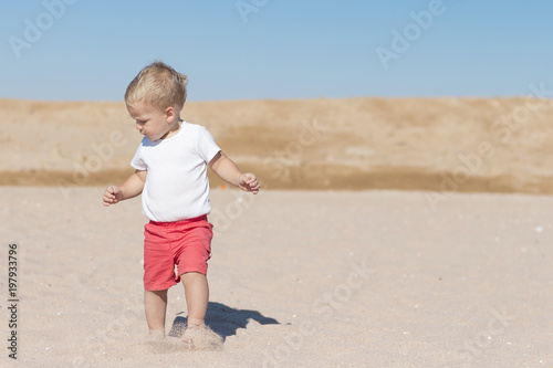 funny toddler on the seaside. concept for travel ad. copy space