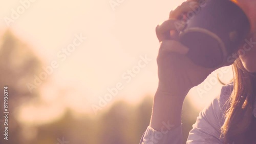 Dolly Shot - Beautiful Young Woman In Casual Clothes Drinking Hot Tea From A Thermos Cap During A Picnic In Nature On A Sunny Summer Day