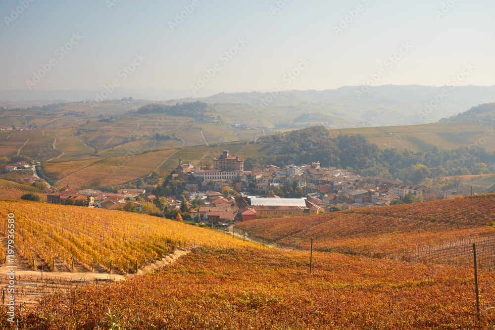 Barolo town in autumn, vineyards with yellow leaves in a sunny day in Italy