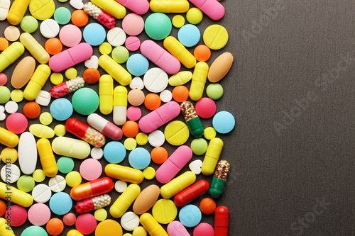 Colorful pills on grey background