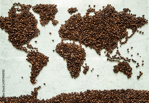 The world map from coffee beans on a light concrete background