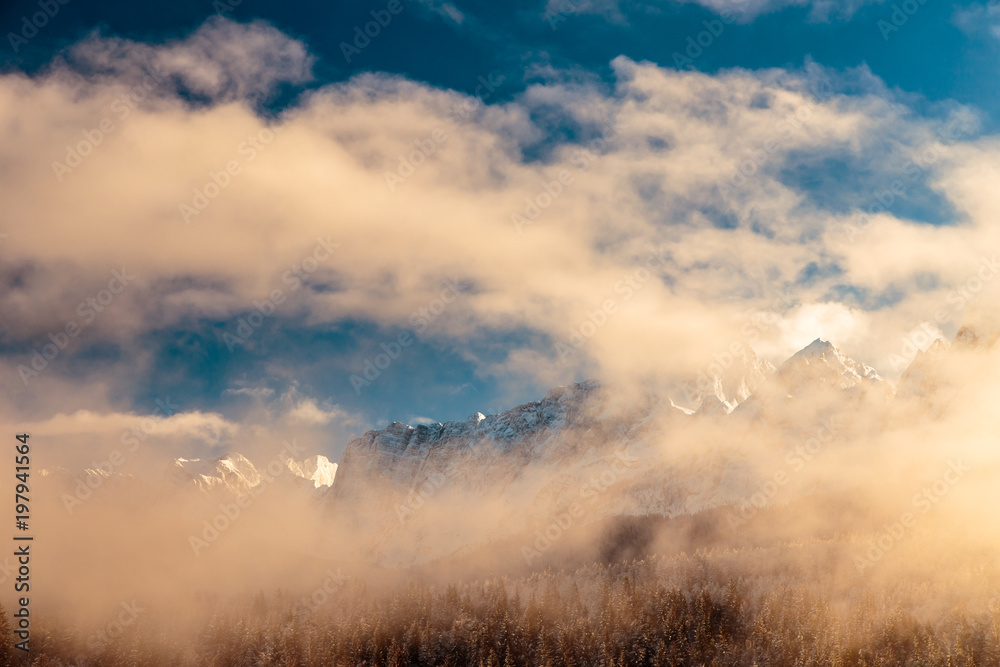 Mangart capped by the fog in a winter day Mangart capped by the fog in a winter day