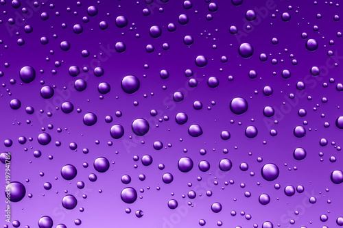Nice ultraviolet gradient color background from water drops of the different size. Abstract background