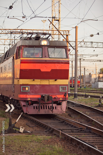 Closeup of railway track with old locomotives and old manual hand operated railroad switch in summer evening day, front view, vertical/ Transportation, railway concept