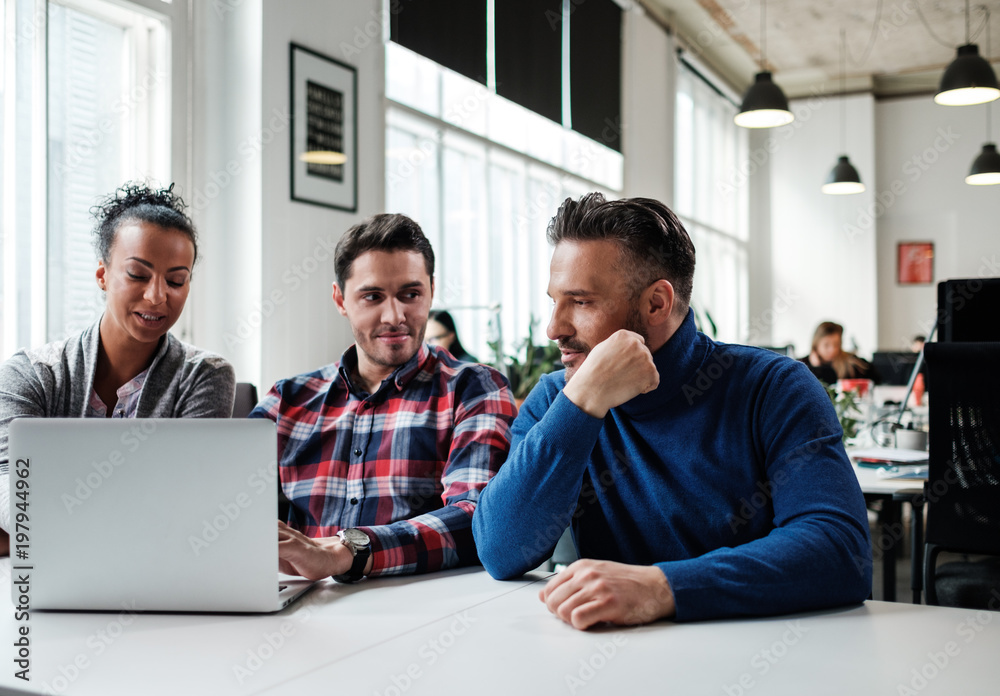 Multi-ethnic colleagues in a coworking office. Multi-ethnic colleagues in a coworking office.